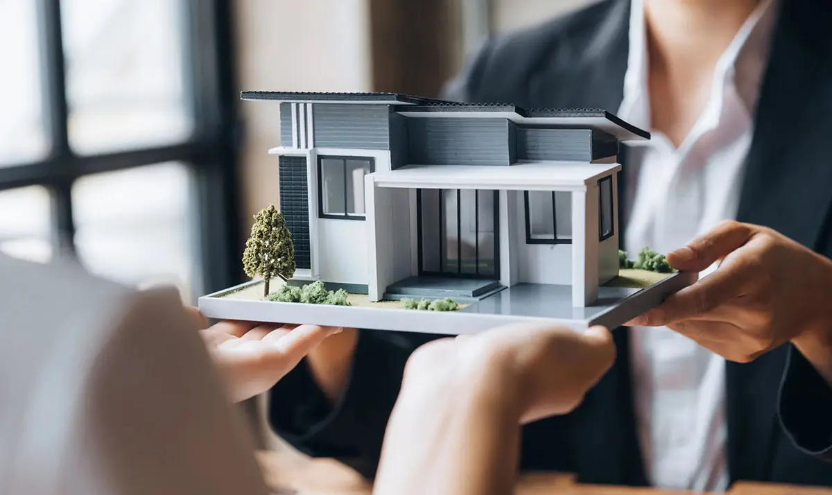 Person giving tiny house as sarasota real estate to another person